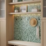 Green mosaic tile wall with glossy, textured surface and small hexagonal pattern.
