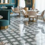 Bright, patterned ceramic tile with blue, white, and gold accents, featuring a geometric design and glossy finish.