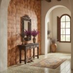 A warm-toned wooden textured tile wall with geometric pattern in a cozy entryway.