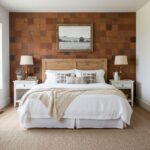 Terracotta tile wall with warm earthy tones and textured surface behind a cozy bed.