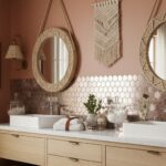 Pink hexagon tile with a matte finish and subtle texture, complemented by round mirrors and natural decor accents.