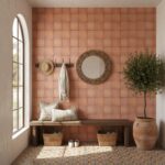 Warm terracotta tile wall with textured surface and earthy tones.