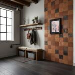 Rustic clay-colored textured tiles on wall, with a framed floral artwork, wooden shelf with plants, and a bench with storage.