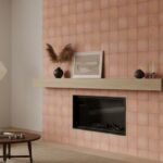 Pink ceramic tile with a textured, matte finish surrounding a built-in fireplace.