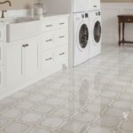 White ceramic tile with a glossy finish and a delicate geometric pattern, ideal for bright, clean laundry or utility rooms.