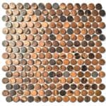A mosaic tile composed of small, round stones in shades of brown, beige, and gray with a textured, natural surface.
