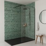 Green geometric patterned tiles with a textured surface in a modern shower enclosure.