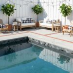 Bright, patterned tile with a sleek, dark finish around the pool.