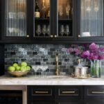 Bright purple flowers and glassware on marble countertop.