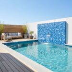 Bright blue mosaic tile with textured surface for pool water features.