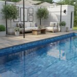 Bright blue mosaic tile with textured surface, used for pool deck flooring.