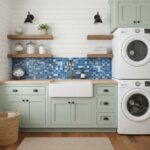 Bright mint green cabinetry with a white farmhouse sink and a vibrant blue mosaic tile backsplash. Modern laundry appliances.