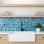 Blue mosaic tile with textured surface and glossy finish, arranged in a grid pattern behind the sink.