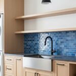 Blue mosaic tile with glossy finish and textured surface in a modern kitchen setting.