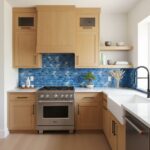 Bright blue mosaic tiles with a glossy finish, textured surface, used as a kitchen backsplash behind the stove and countertop.