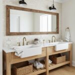 Double sink vanity with wooden accents, white ceramic basins, and natural woven baskets.