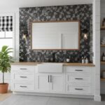 Black, gray, and white mosaic tile wall with textured surface.