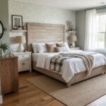 Bright bedroom featuring a rustic wooden bed frame with white bedding and plaid accents, complemented by neutral decor and na.