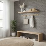 A modern entryway featuring a textured gray brick wall, a wooden shelf with decorative items, and a matching wooden bench wit.