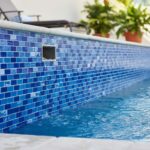 Blue mosaic tile with textured surface for pool lining.