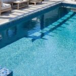 Blue mosaic tile with textured surface and glossy finish.