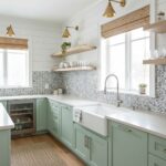 Bright mint green kitchen with mosaic tile backsplash and white countertops.