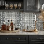 Gray and white mosaic tile backsplash with textured surface and small square pattern.