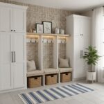 Bright entryway featuring white cabinetry, beige textured tiles, and a striped rug, accented with a potted plant and decorati.