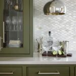 Green textured ceramic tile backsplash with a diamond pattern.