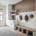 Hexagon wall tiles in neutral tones with a textured surface, creating a contemporary and stylish entryway accent wall.