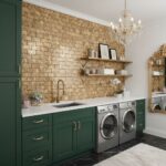 Beige brick-patterned tile wall in laundry room with green cabinetry and modern appliances.
