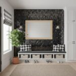 Black mosaic tile wall with a whiteboard, black and white checkered cushions, and a potted plant in a modern interior.