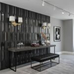 Black geometric patterned ceramic tile wall with modern decor accents.