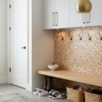 Colorful mosaic tile with textured surface in warm beige tones.