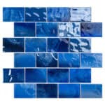 Blue ceramic tiles with glossy, textured surface and irregular patterns.