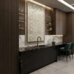 Neutral stone-colored textured tile wall with a subtle pattern, complementing modern kitchen cabinetry and decor.