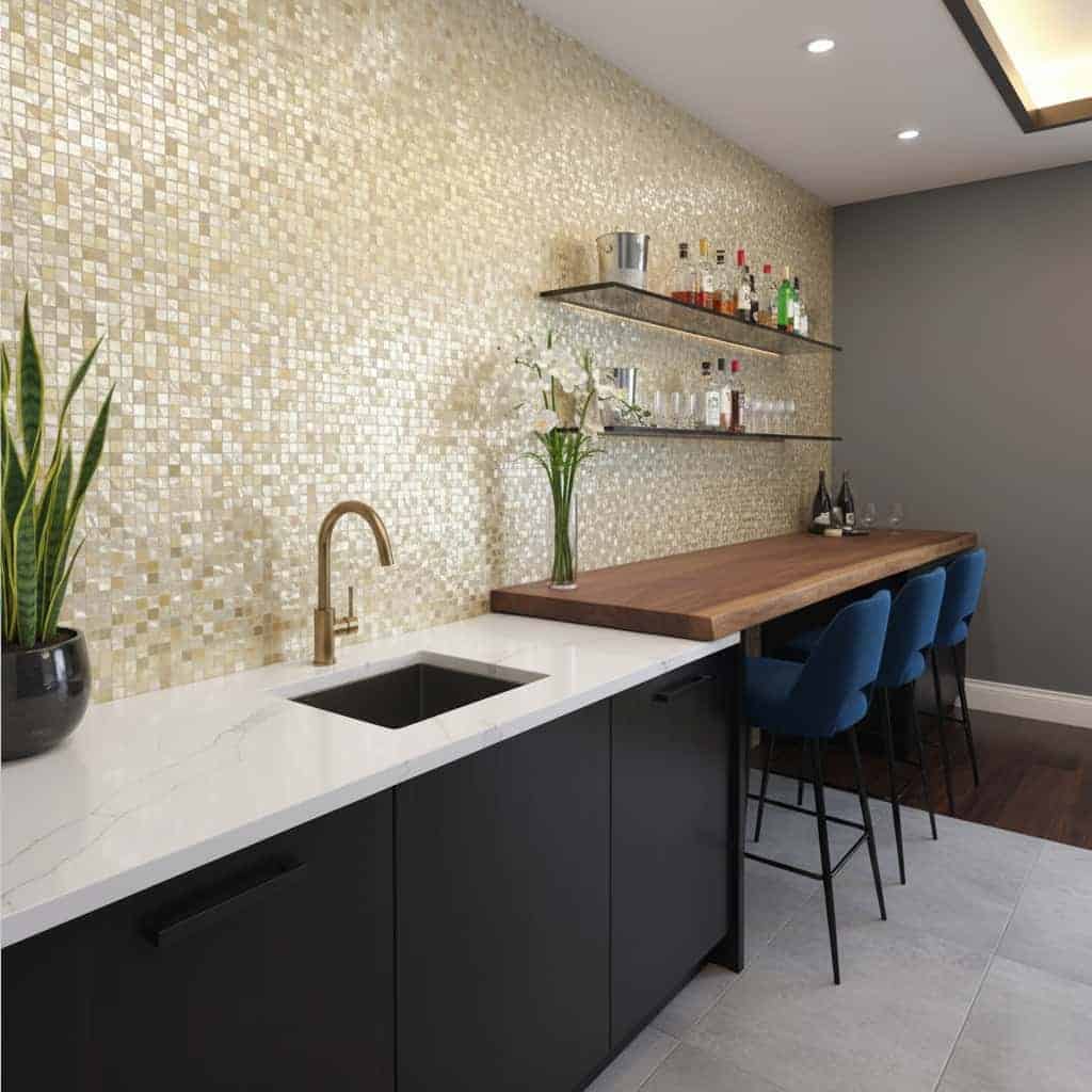 Beige mosaic tile with textured surface, complementing a sleek kitchen bar area.