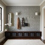 Gray hexagon tile wall with textured surface, contemporary style, in a home entryway.