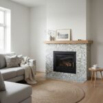 Cozy living room with a mosaic tile fireplace featuring neutral tones and a textured surface, complemented by minimalist deco.