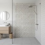 Beige mosaic tiles with textured surface in a modern shower area.