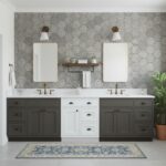 Gray hexagon textured tile wall with white and dark gray double vanity and gold fixtures.