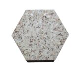 Hexagon terrazzo tile with beige and light brown tones, featuring a smooth texture and a mix of small stone chips.