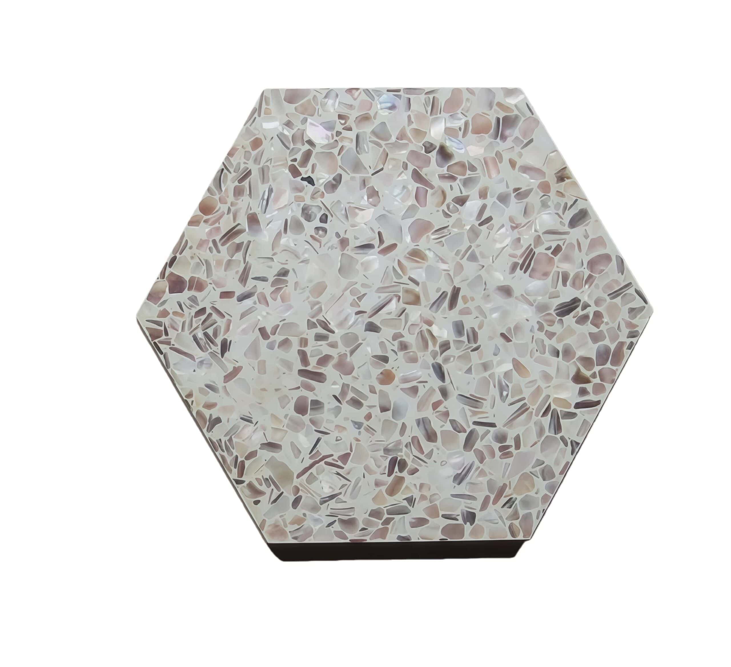 Hexagon terrazzo tile with beige and light brown tones, featuring a smooth texture and a mix of small stone chips.