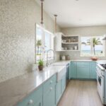 Bright mosaic tile backsplash in neutral tones with a textured surface.