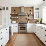 Beige mosaic tile backsplash with textured surface in a modern kitchen.