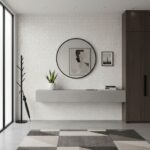 White textured wall tiles with a subtle geometric pattern, paired with a monochrome rug featuring various shades of gray.