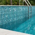Blue mosaic tile with glossy finish and textured surface.
