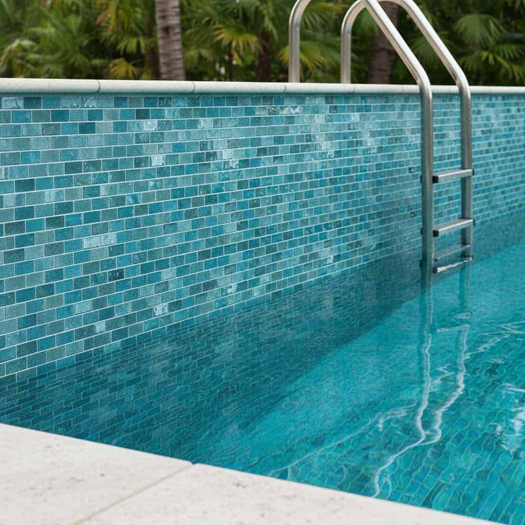 Blue mosaic tile with glossy finish and textured surface.