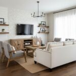 Soft beige and gray fabric sofa with wooden accents and a textured white wall.