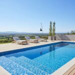 Blue mosaic tile with textured surface for pool edges and steps.